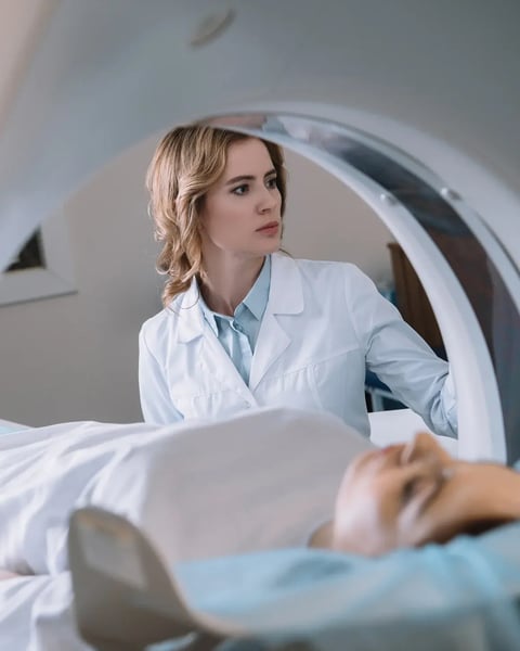 female nurse assisting with MRI scan