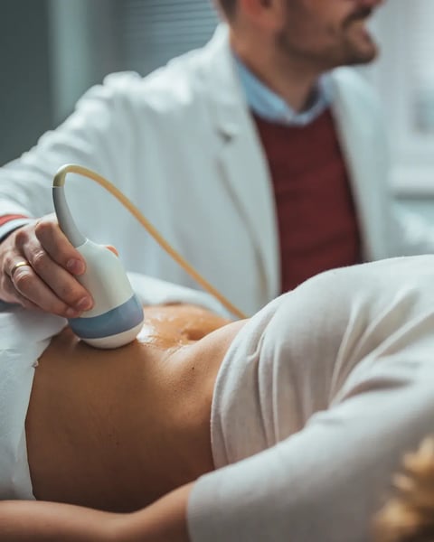 man scanning woman stomach