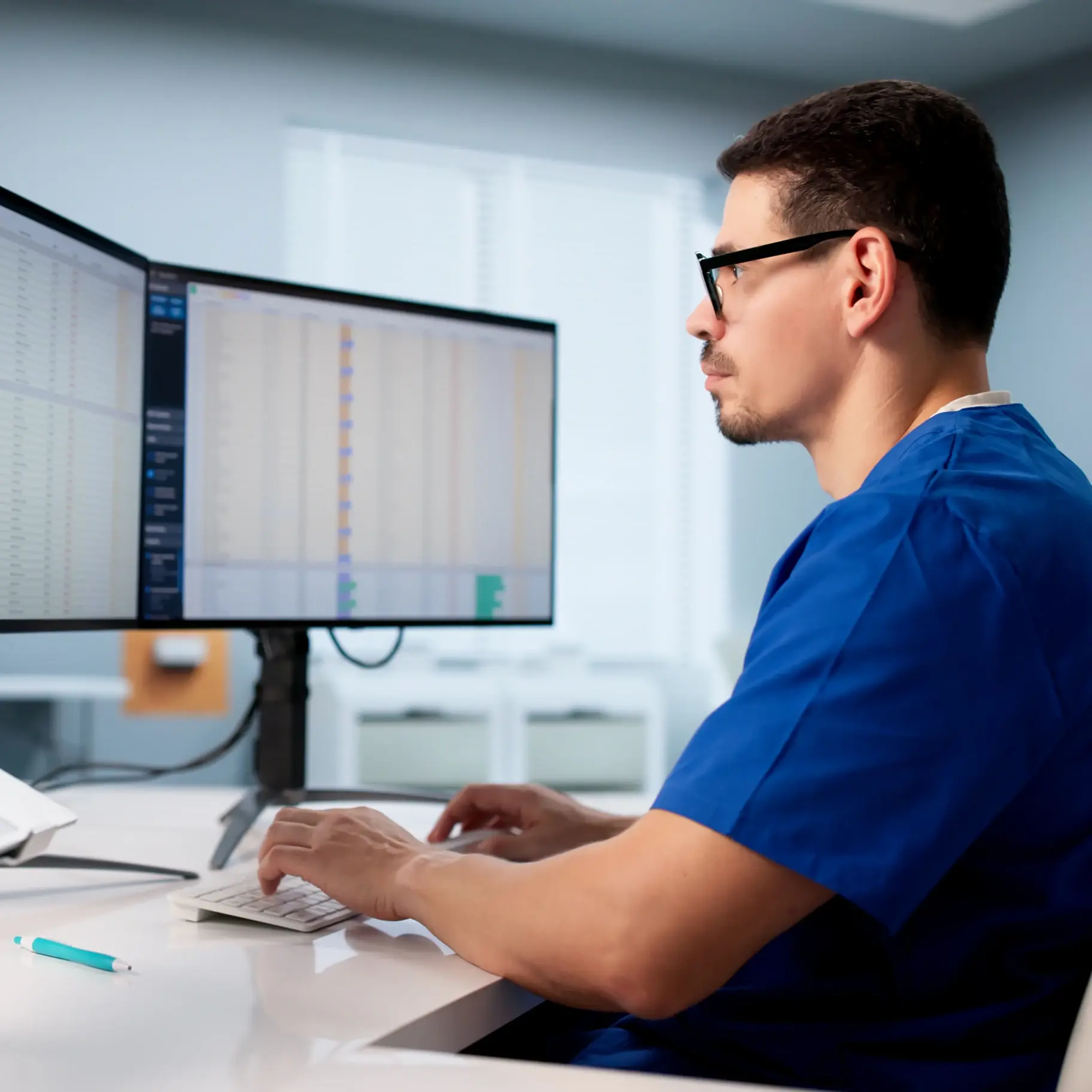Doctor-working-at-desk-on-computer