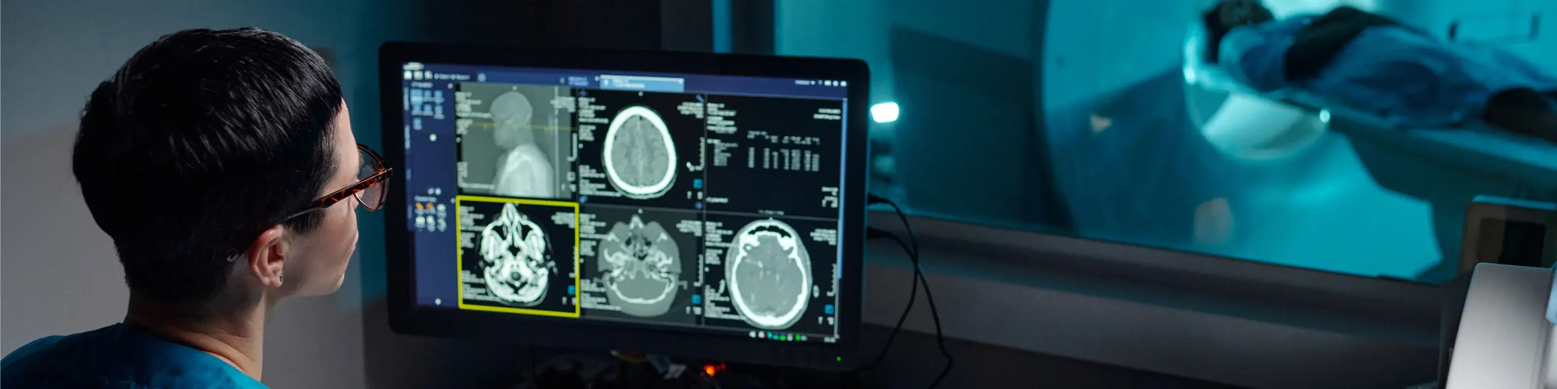 Male-nurse-looking-at-monitor-showing-scan