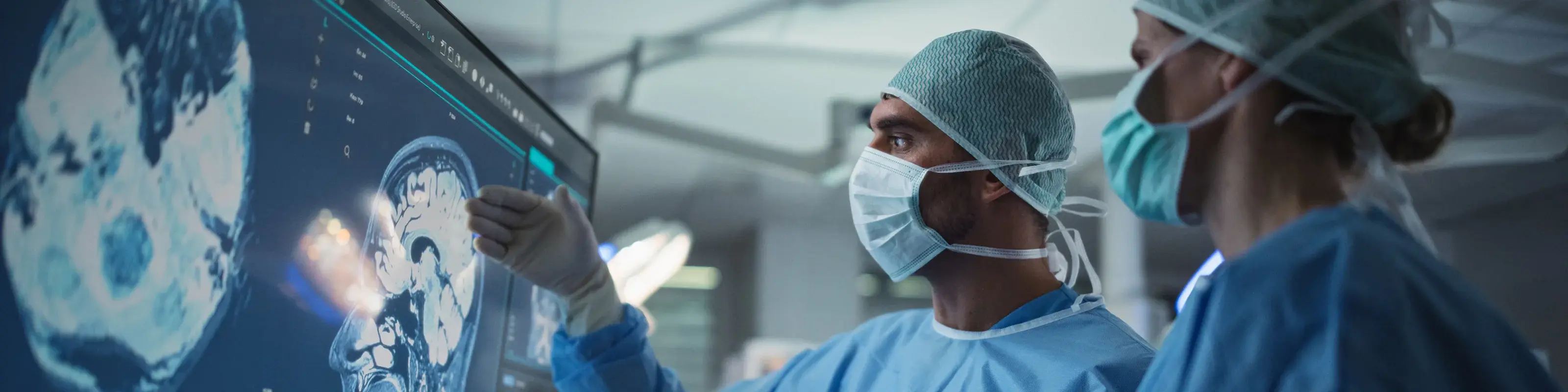 two people looking at scans on big screen